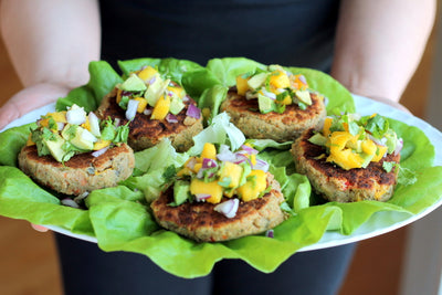 Spicy Chickpea Lentil Burgers topped with a sweet and delicious mango avocado Pico!